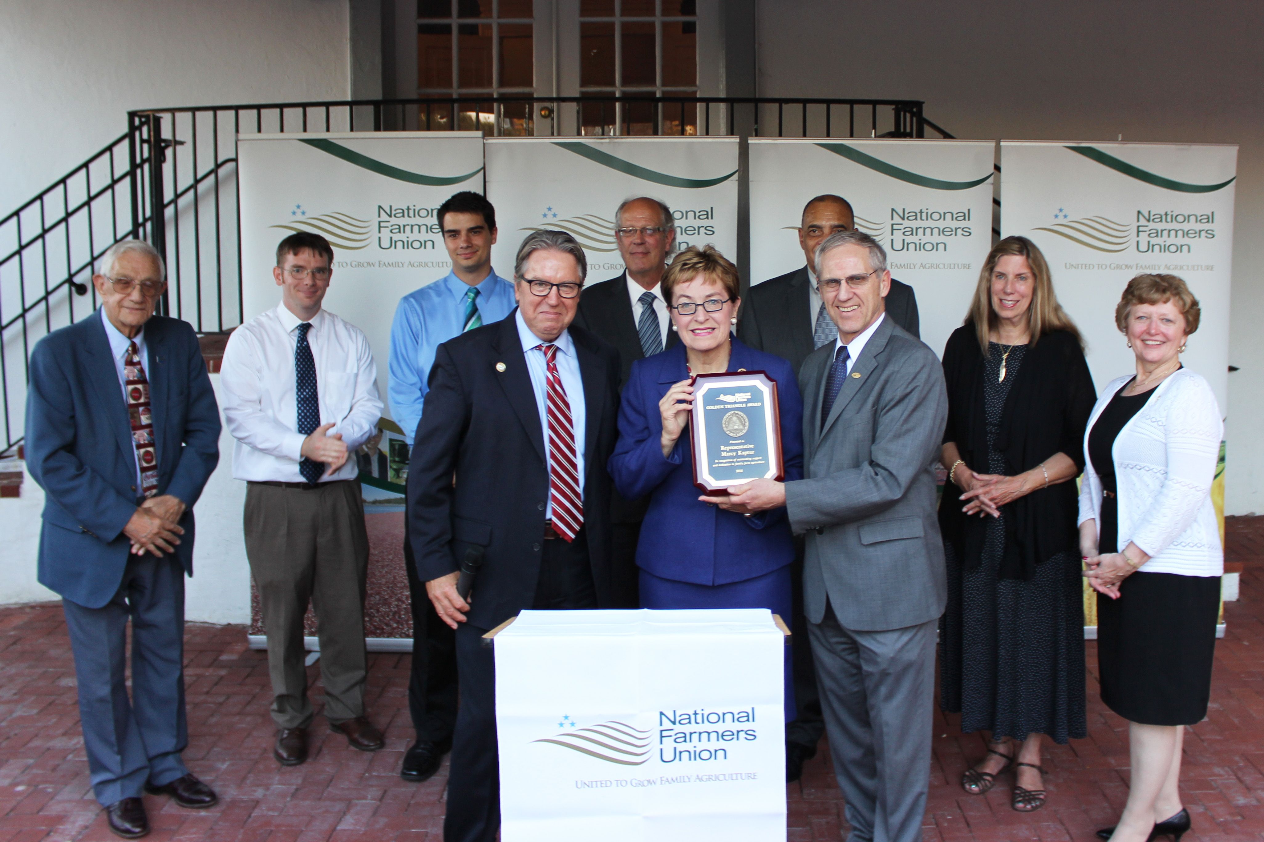 U.S. Rep. Marcy Kaptur, flanked by OFU President Joe Logan, left, and NFU President Roger Johnson, right, receives NFU's Golden Triangle Award for 2015.